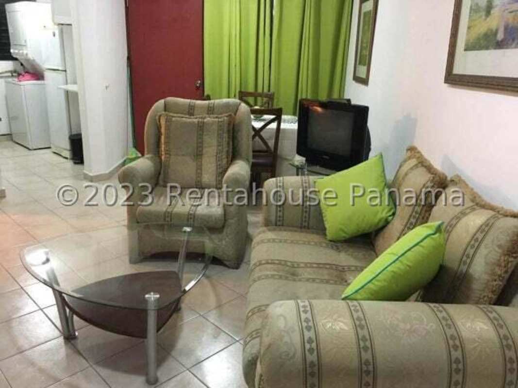 Living and dining combined area with tiled flooring, curtains, sofa, and dining table in PH Campo Limberg Panama