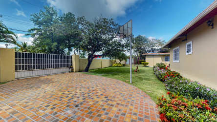 Brick driveway with basketball hoop and garden yard luxury residence in Panama