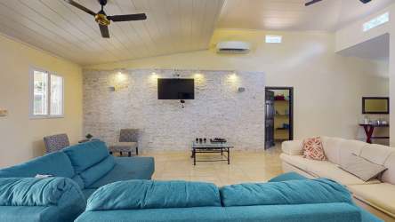 Spacious living room high ceiling sofas chandeliers tile floor in San José Panama