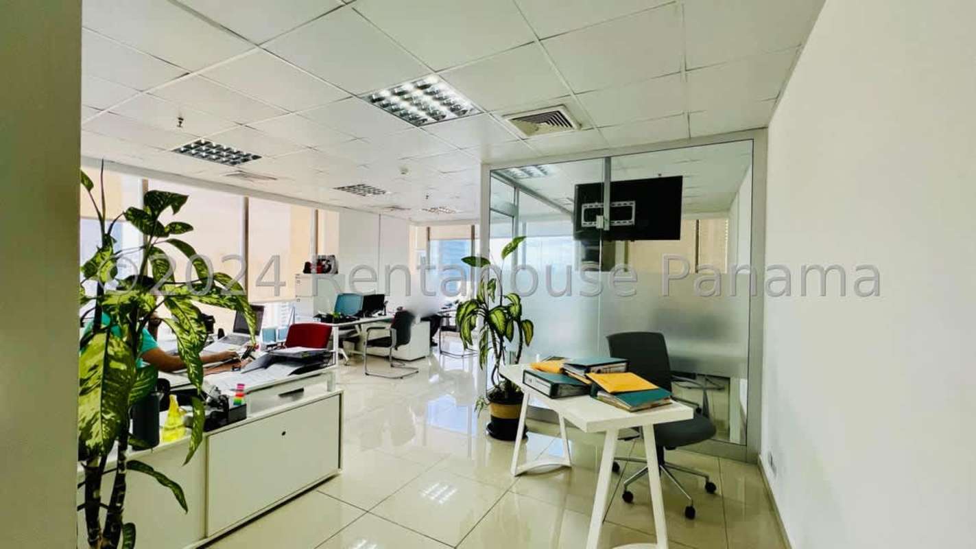 Glass partitioned executive office space with city view in Twist Tower Obarrio Panama