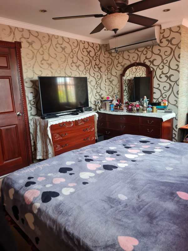Enclosed patio sunroom with wicker furniture and large windows in Altos de Santa María Panama