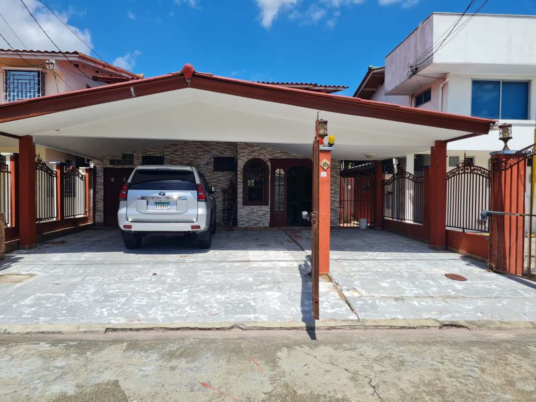 Bedroom with TV, wooden furniture, ceiling fan and AC in Altos de Santa María Panama