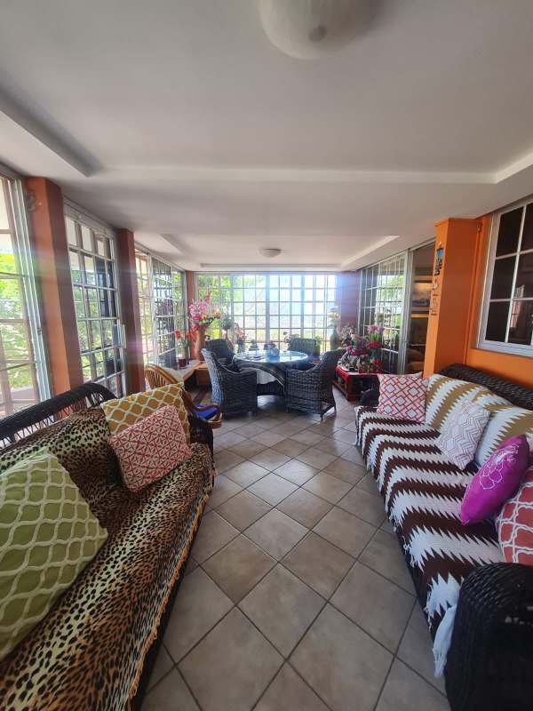 Bedroom with large TV, ceiling fan, air conditioning, and classic decor in Altos de Santa María house Panama