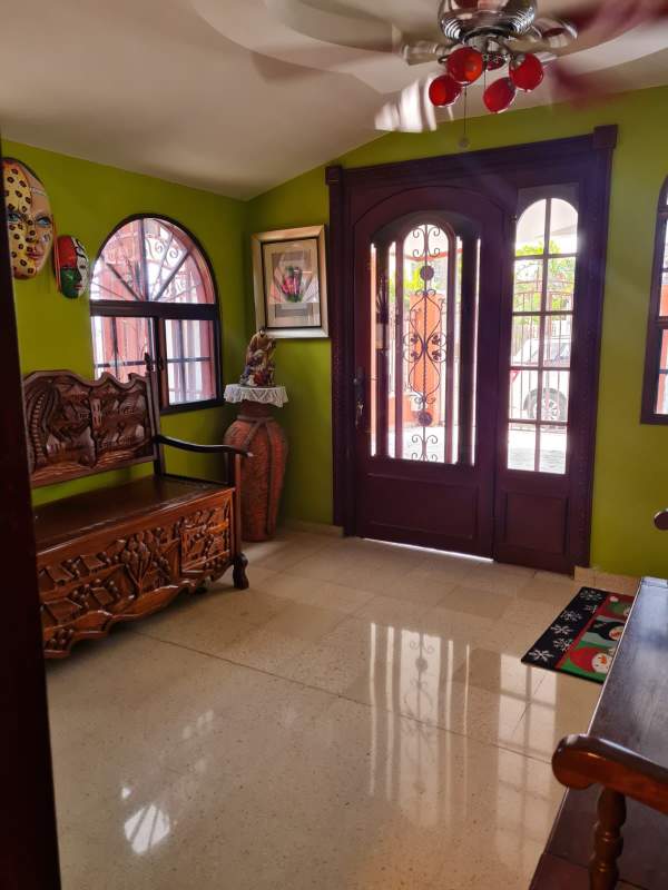 Bathroom with colorful ceramic sink and glass shower door in house Altos de Santa María Panama