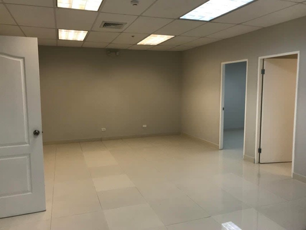 Interior glass door office space with tiled floor in Banesco Tower Banking District
