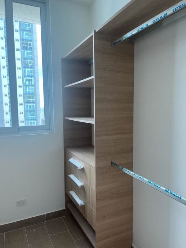 Light-filled walk-in closet with built-in shelves and city views PH Bella Vista Park Panama