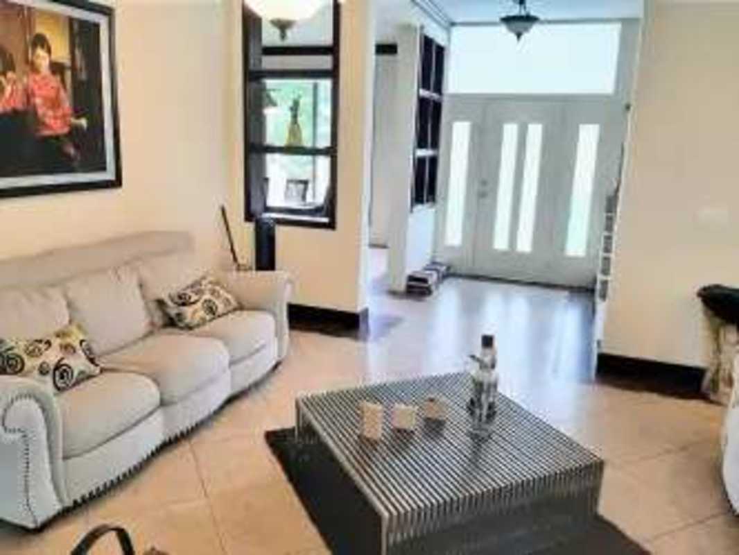 Contemporary living area with tile floors large windows AC clayton rental house Panama