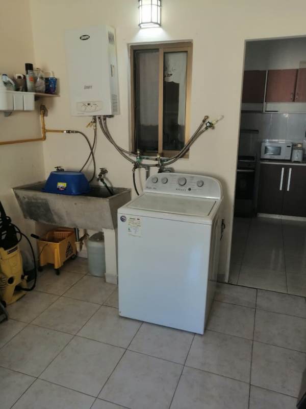 Bright open-plan living and dining room in duplex house Cerro Viento with tile floors Panama City