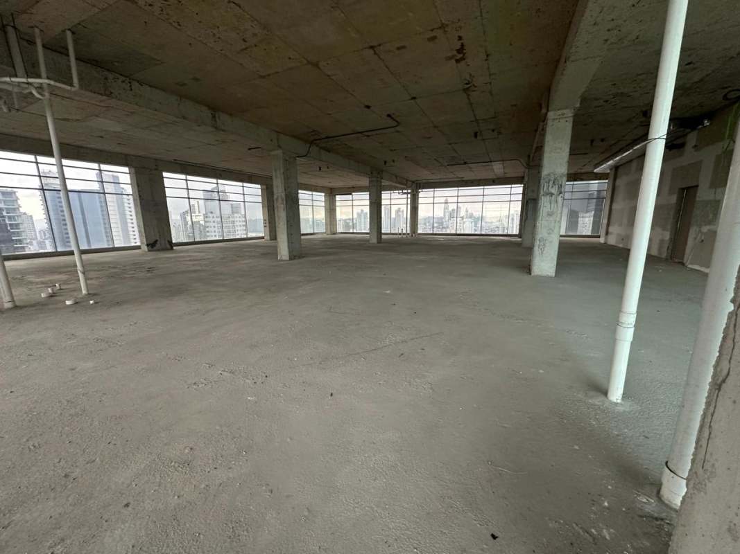 Spacious unpainted open commercial floor with concrete ceiling and windows in Sortis Business Tower Obarrio Panama City