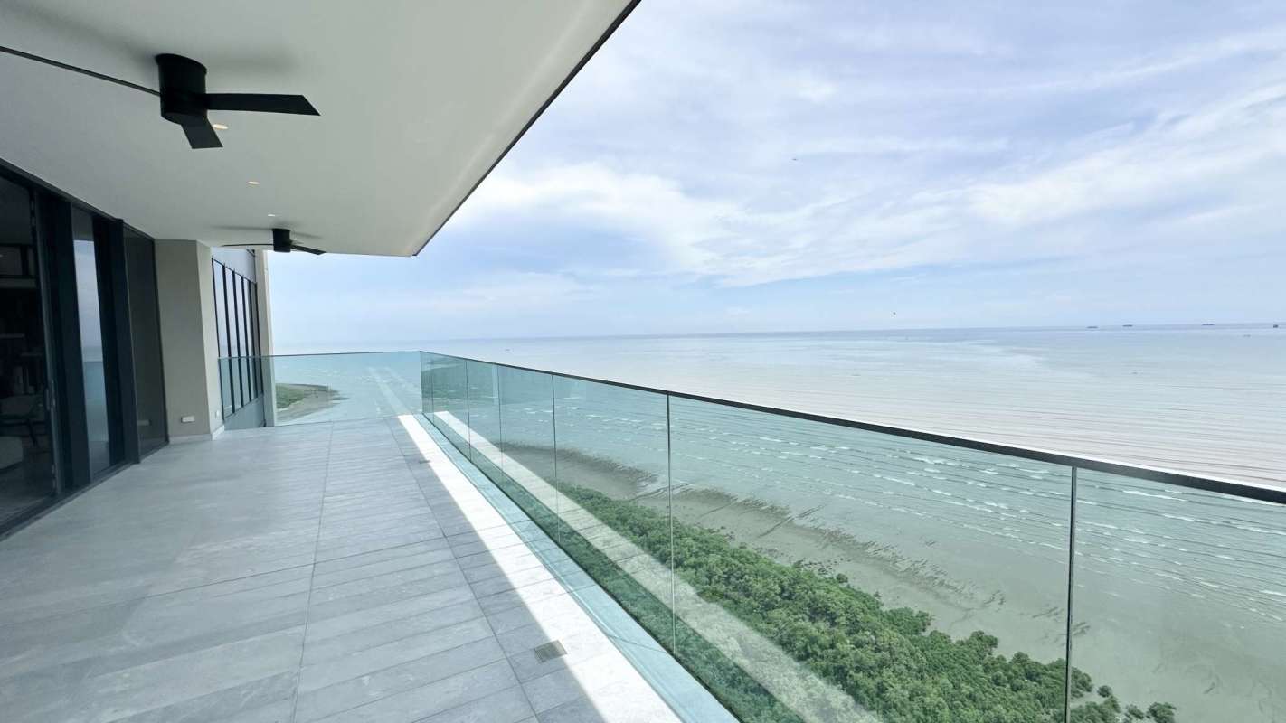 Large living room with floor-to-ceiling windows and ocean view Upper East Costa del Este Panama