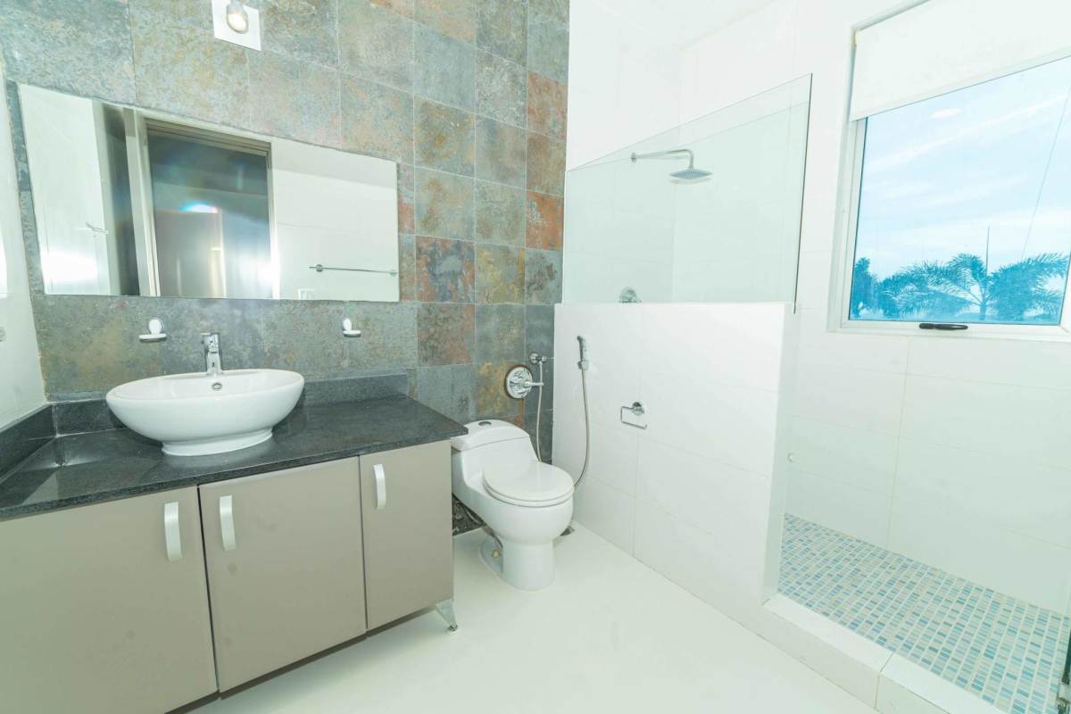 Luxurious bathroom with marble countertops and glass shower at Q Tower Panama