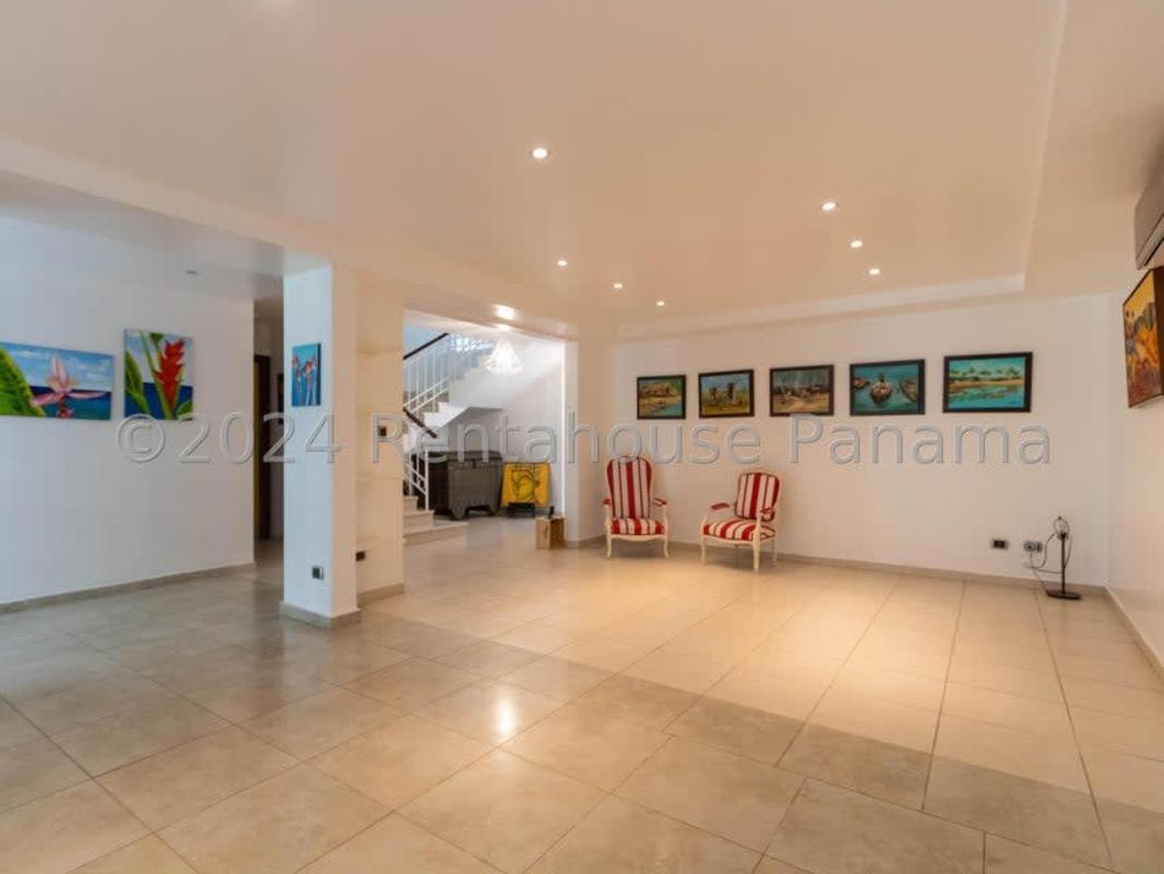 Spacious covered terrace with ceiling fans, hammock, dining area overlooking the pool in Clayton Panama