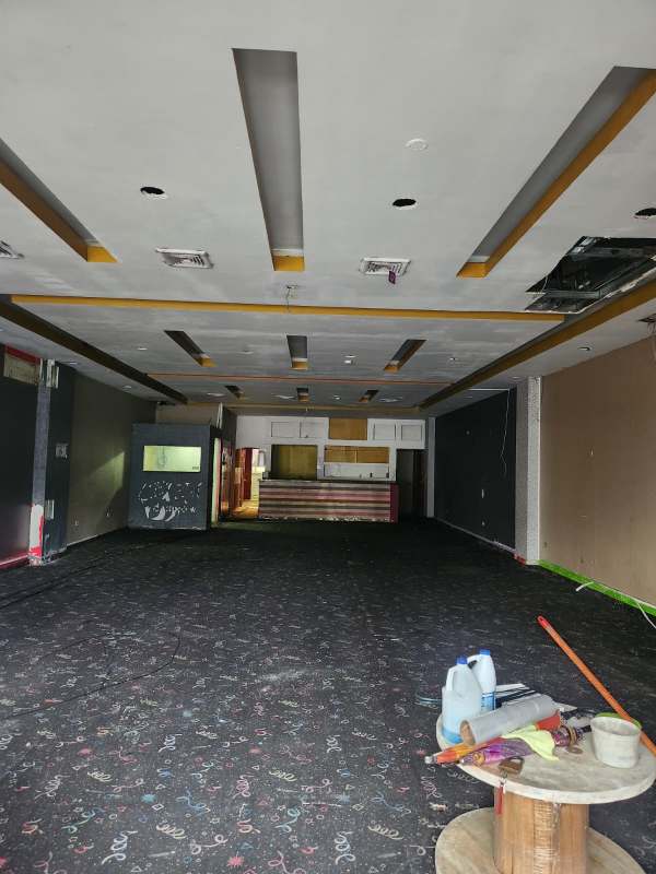 Small utility room with shelving and exposed wiring inside commercial property at La Gran Estación Panama City