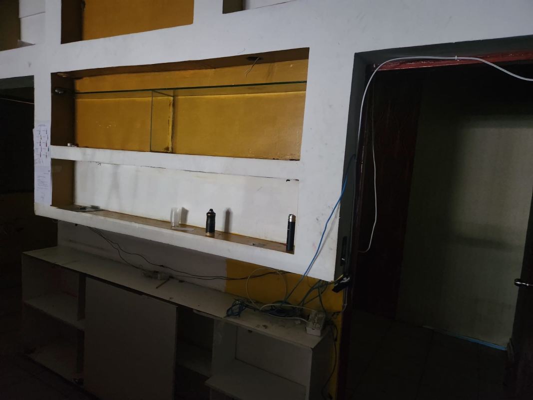Interior space with wall shelving, wiring exposed inside commercial building La Gran Estación Panama City
