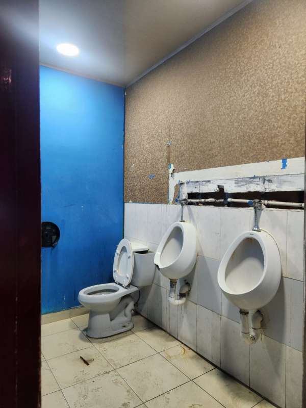 Bathroom interior with double sinks, granite counter, striped colorful wall in commercial mall Panama