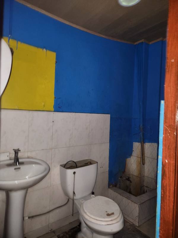 Lobby area glass entrance with patterned carpet under renovation in La Gran Estación mall Panama