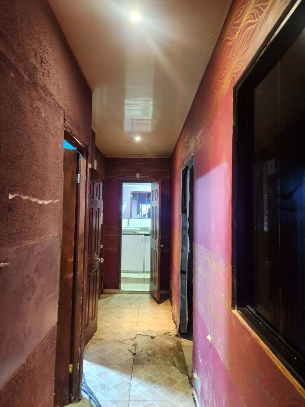 Large hall with drop ceiling lights, patterned carpet, counter and advertising banner at La Gran Estación Panama