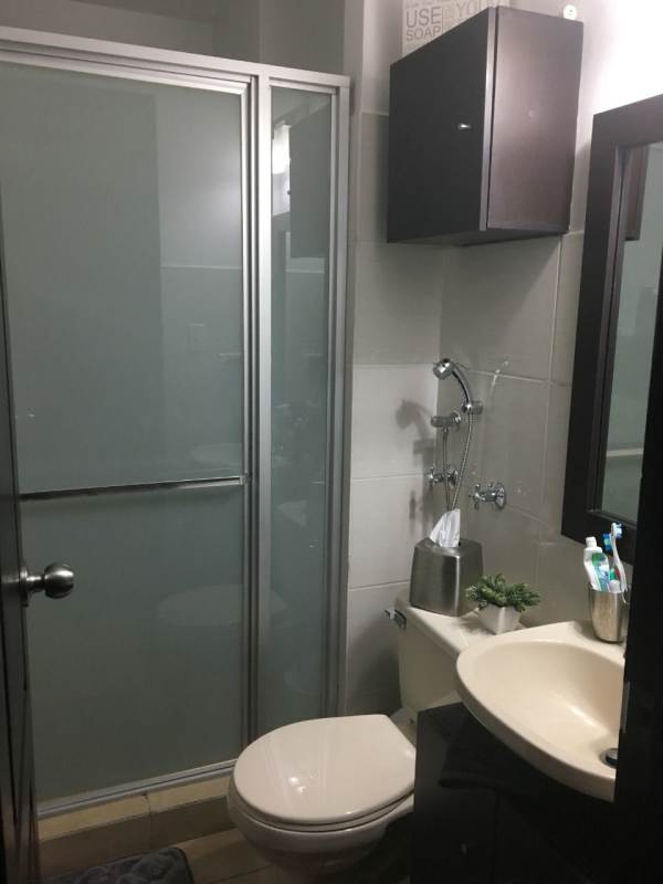 Dining area with wooden table, open kitchen, wall art PH Parque Lefevre Sky Panama City