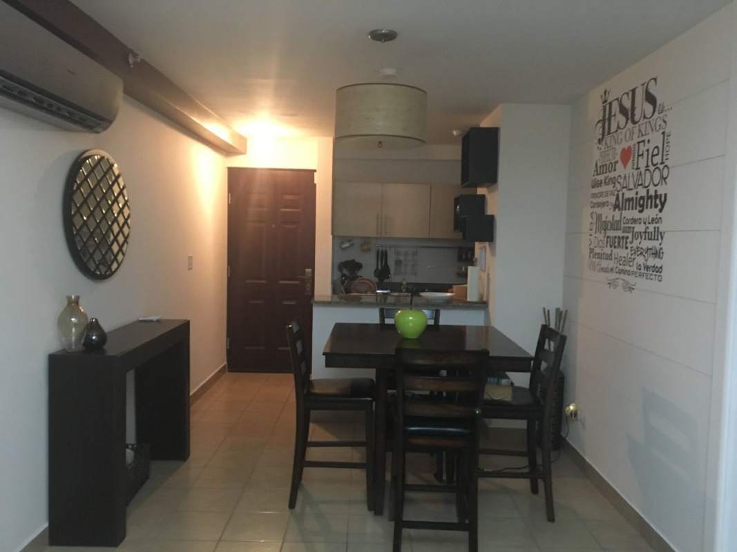 Apartment living room with large windows and nighttime city view in Parque Lefevre Sky Panama