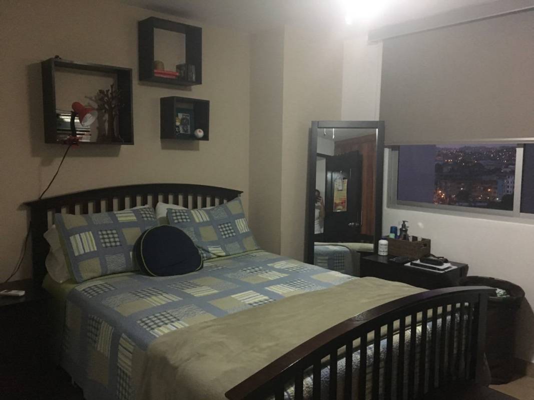 Cozy bedroom with decor, large window and city view PH Parque Lefevre Sky