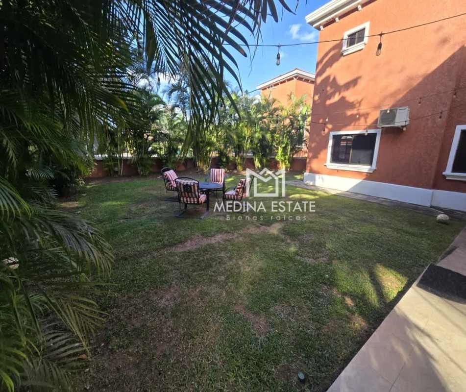 Expansive lush garden with mature trees at spacious Spanish-style home rental in Clayton Panama