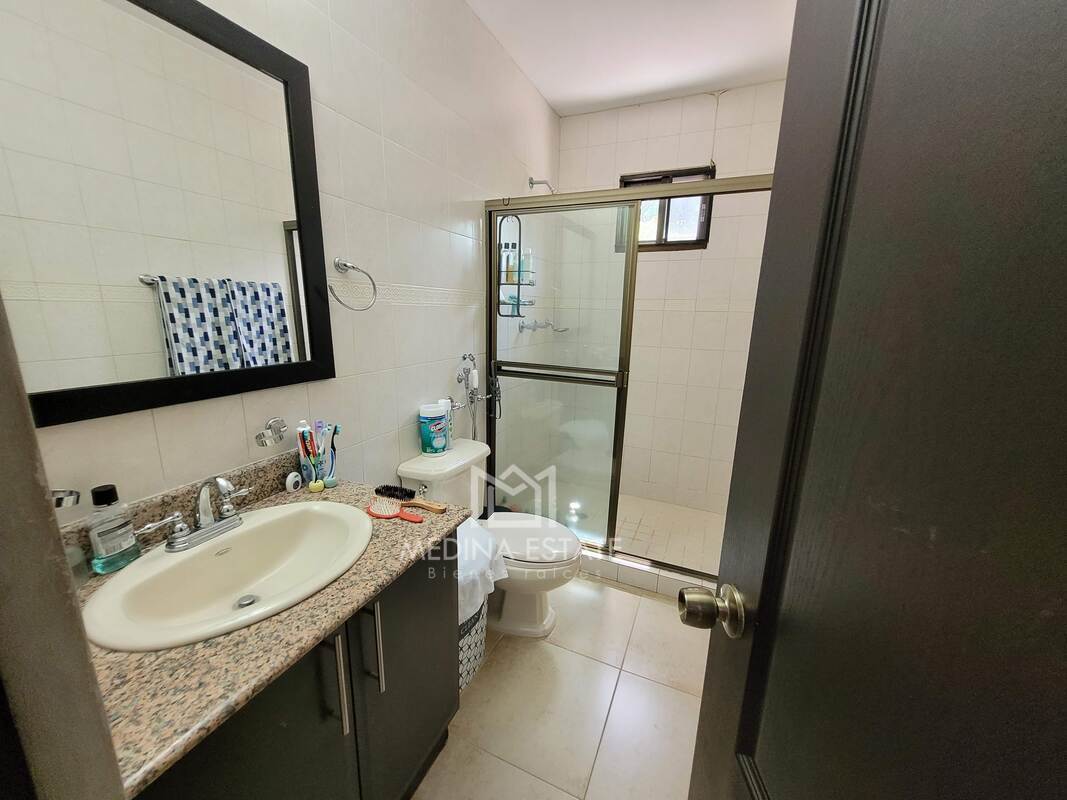 Modern bathroom with granite countertops and glass enclosure luxury home Clayton Village Panama