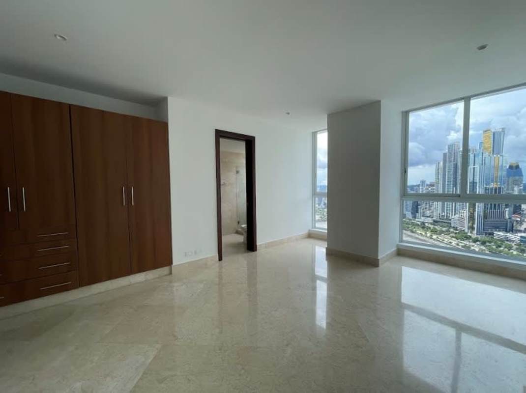 Luxury master bedroom with floor-to-ceiling windows and ocean skyline views at PH The Point Punta Paitilla