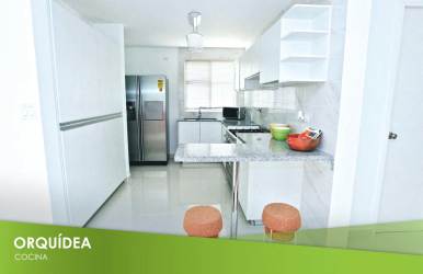 White modern kitchen with marble countertops stainless steel appliances and breakfast bar EcoGardens Arraiján