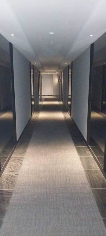 Open kitchen with stainless appliances marble floors in luxury apartment Nuovo by Armani Panama