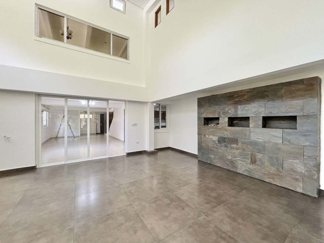 Spacious traditional kitchen with granite countertops and wooden cabinetry in Cardenas Clayton Panama