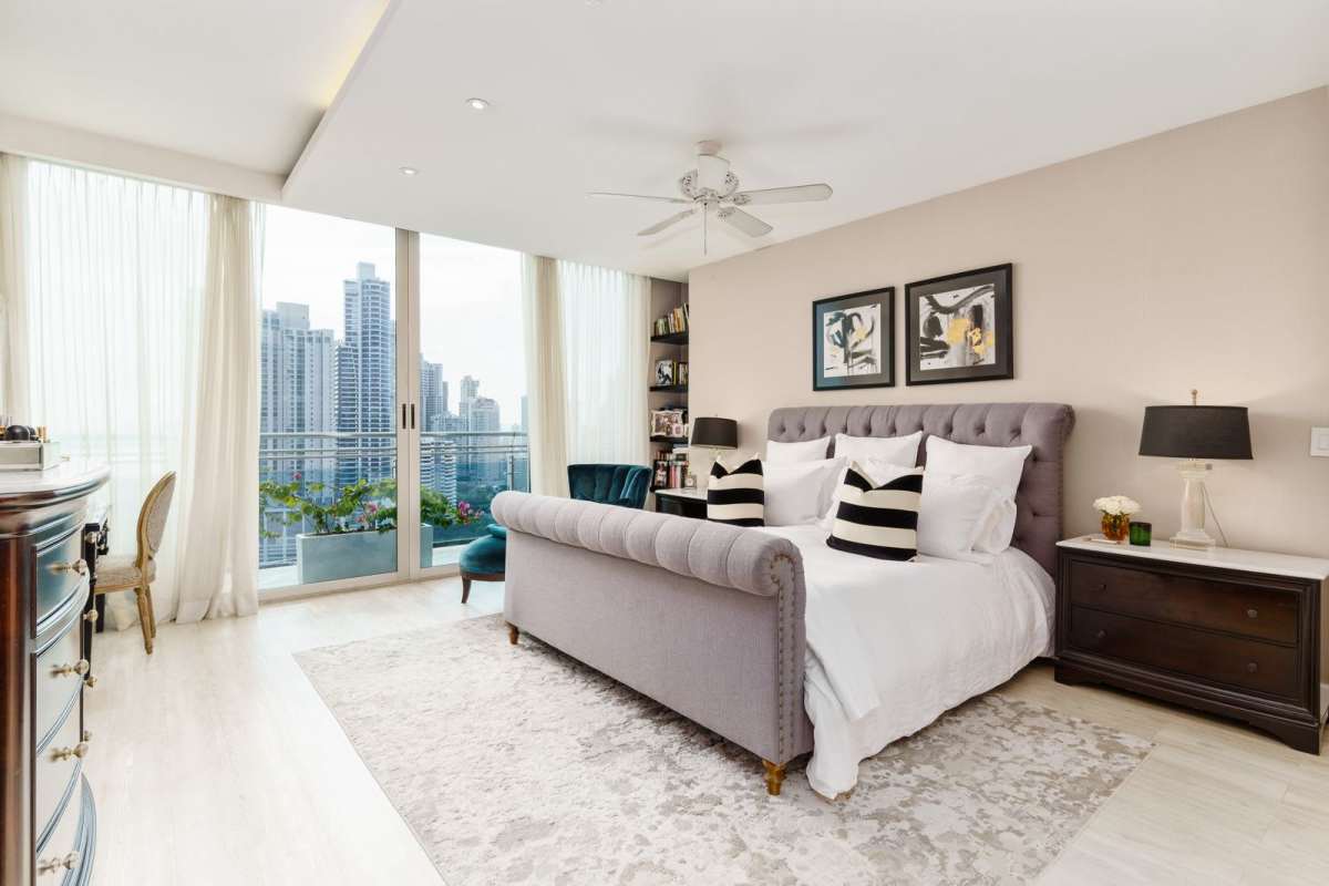 Spacious living dining area with panoramic windows, chandelier at PH Aqualina Panama