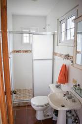 Modern tiled bathroom with glass shower enclosure at Cabuya Playa Gorgona beachfront villa