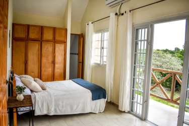 Bedroom with bunk beds and tile floors for multiple guests in beachfront villa Cabuya Panama