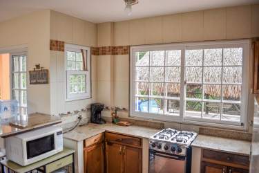 Bright kitchen with granite countertops, gas stove, large windows in beachfront villa Nueva Gorgona Panama
