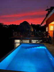 Traditional dining area with ceiling fan, tiled floor and garden views at Gorgona beachfront villa