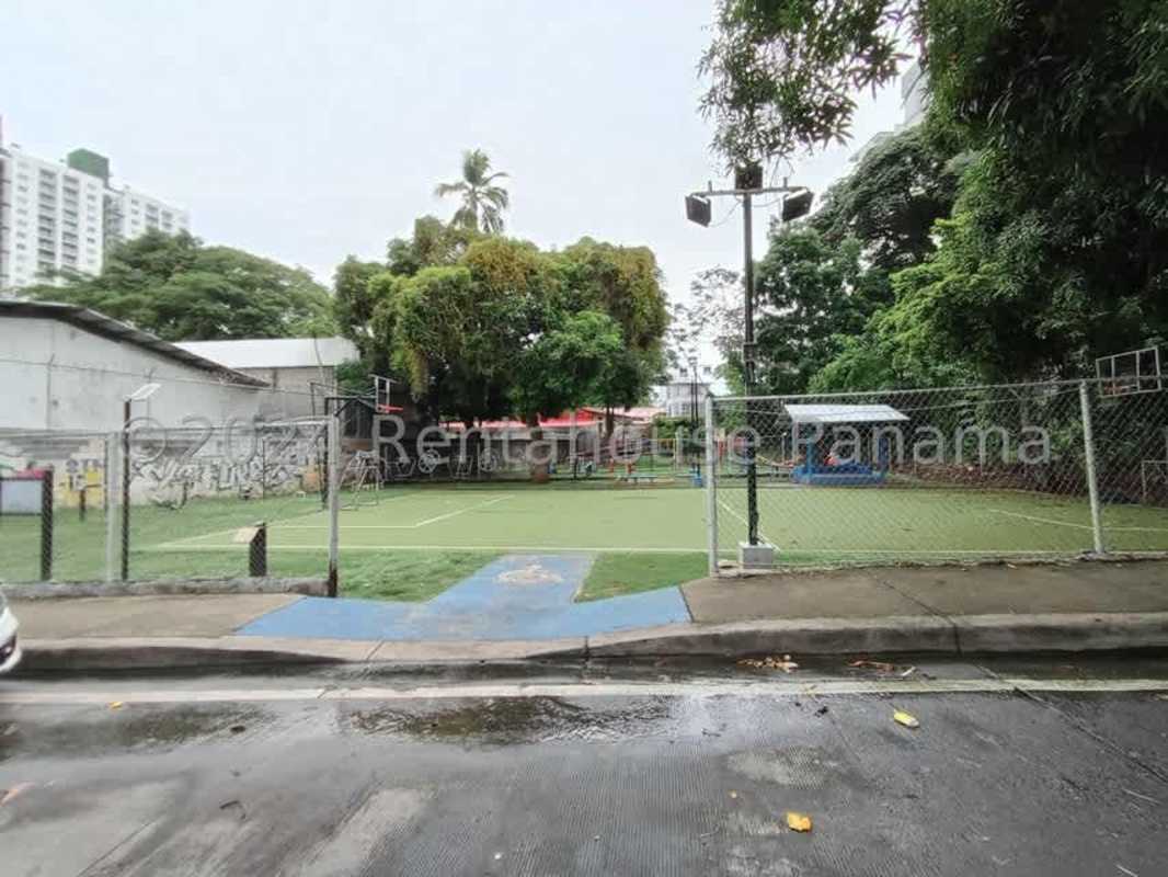 City recreational area with fenced sports court, basketball hoops, graffiti wall near Panama lease lot