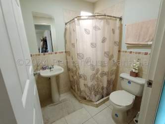 Bright bedroom with closet, window and tiled floor in La Arboleda house for sale Panama