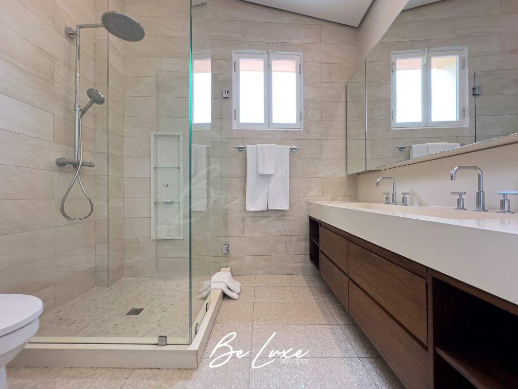 Master bedroom with wood floor, stone wall and balcony in PH Casa Remón Casco Antiguo Panama