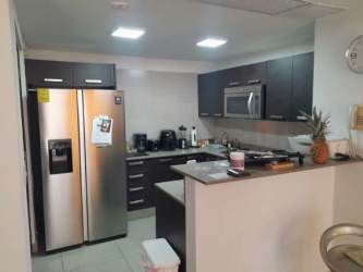 Contemporary kitchen with granite counter and appliances at PH Mosaic Panama Pacifico