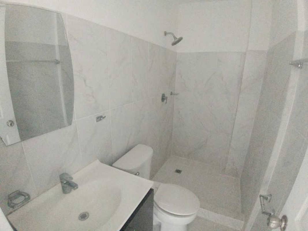 Modern minimalist bathroom with marble tiles and walk-in shower PH Mystic Gates Panama