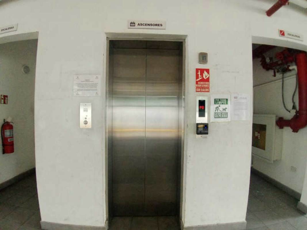 Interior corridor with elevators and emergency signage PH Mystic Gates Panama