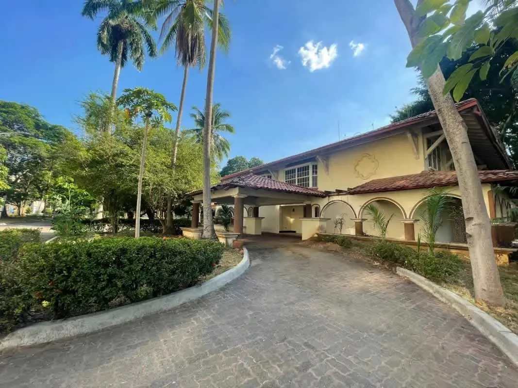 Mediterranean luxury home exterior with arched entryways, large driveway and lush landscaping in Amador Panama