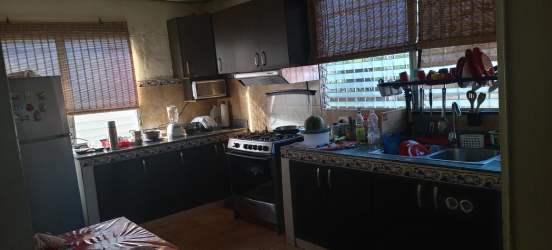 Traditional kitchen with dark cabinets, tiled counters and bamboo blinds Vista Alegre Arraiján Panama