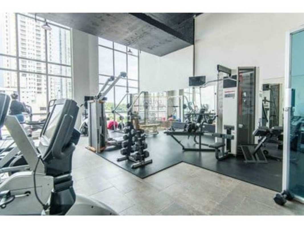 Indoor swimming pool surrounded by plants and stone wall features PH Quartier 74 Panama City