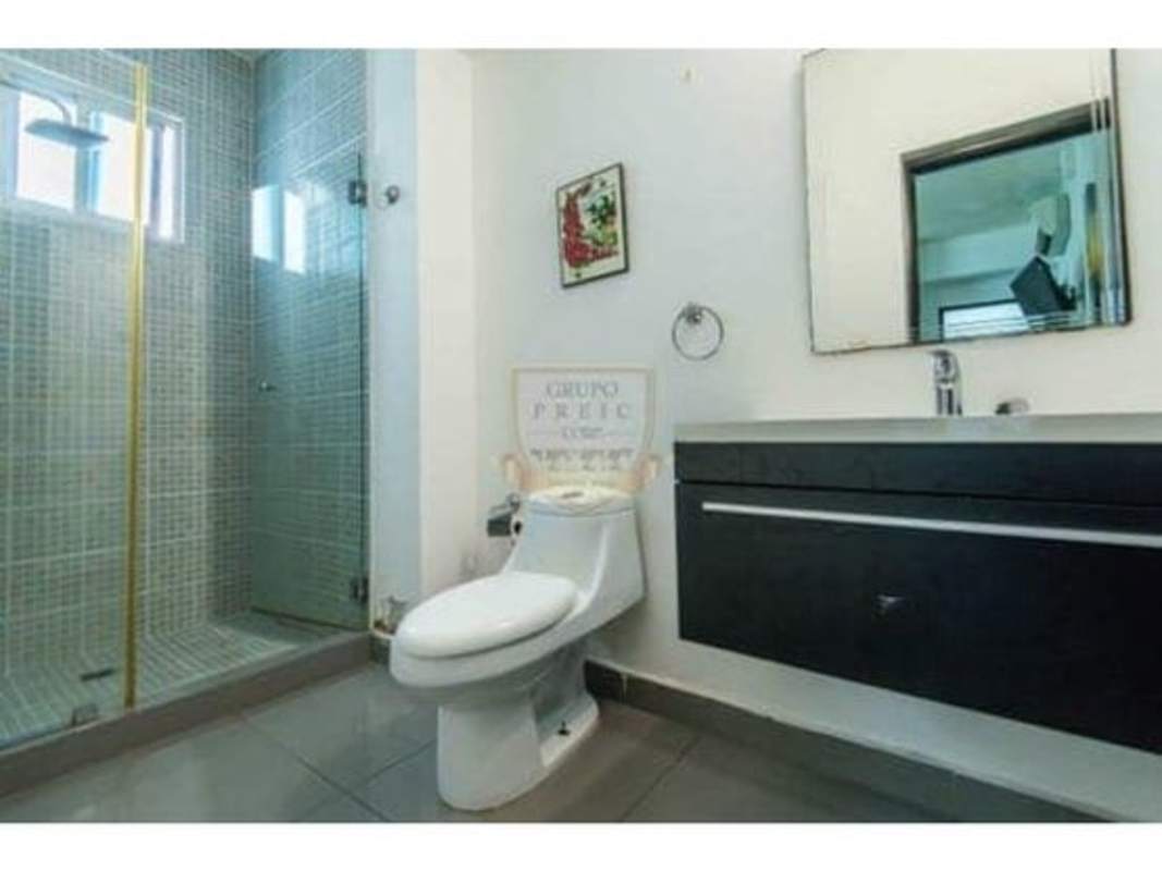 Guest bedroom with two beds, wardrobe, tiled floor, AC in PH Quartier 74 San Francisco Panama