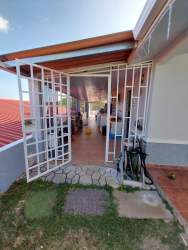 Fenced landscaped yard grass shrubs trees open sky Urbanización Belmonte Panama