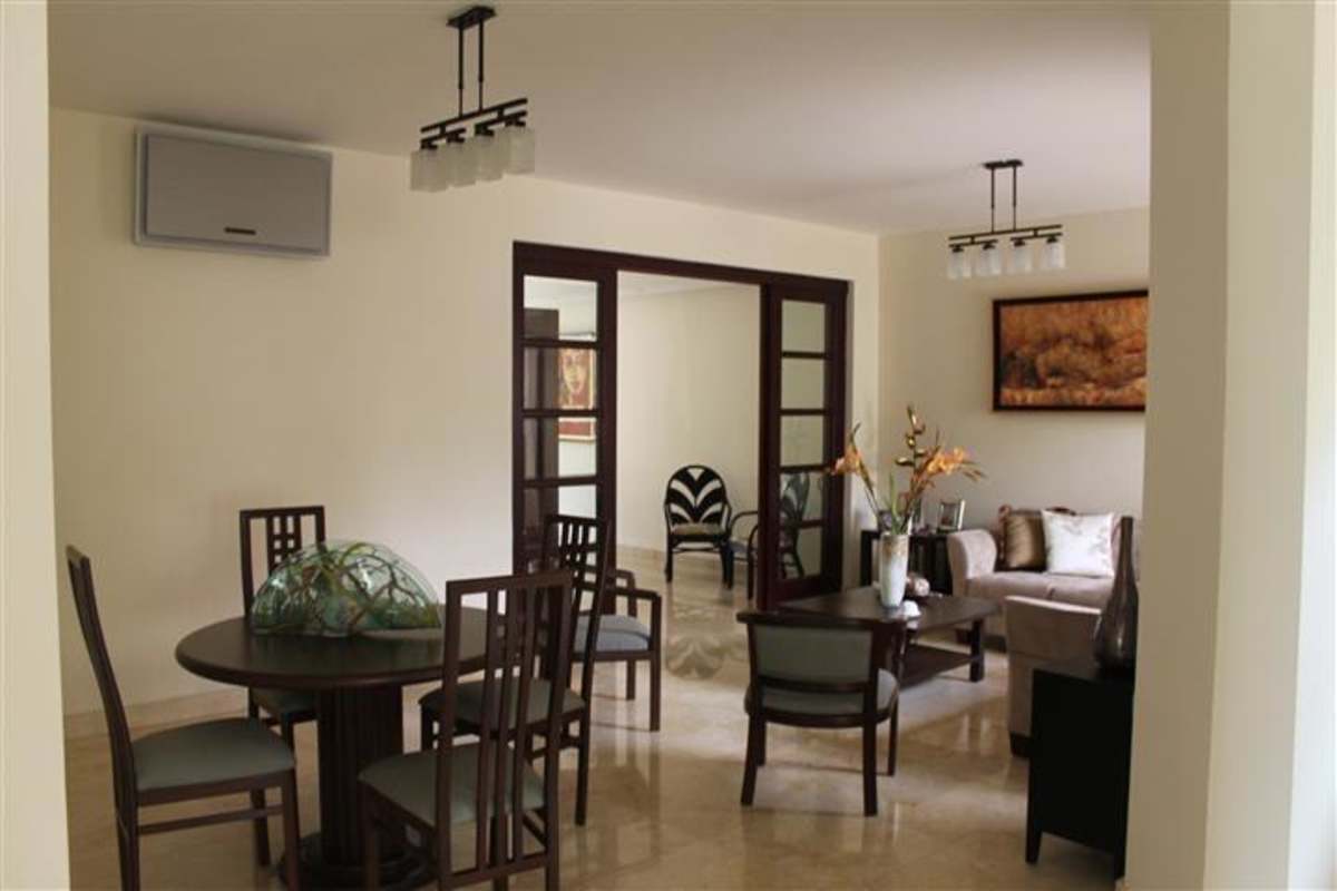 Contemporary entrance hall with artistic staircase and marble floors in Panama villa