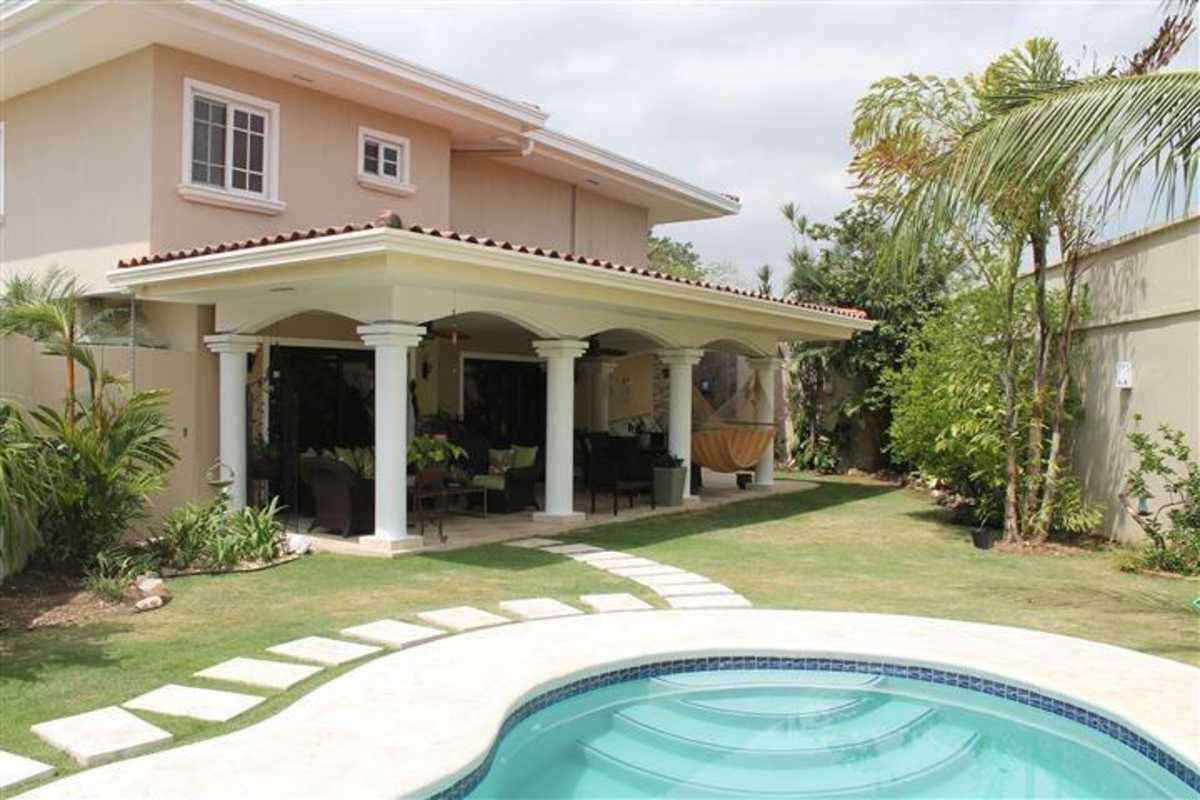Private backyard featuring swimming pool, covered patio, landscaped garden in Las Perlas Villa