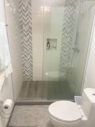 Covered balcony with dining and garden views in Bijao Rodman luxury apartment Panama