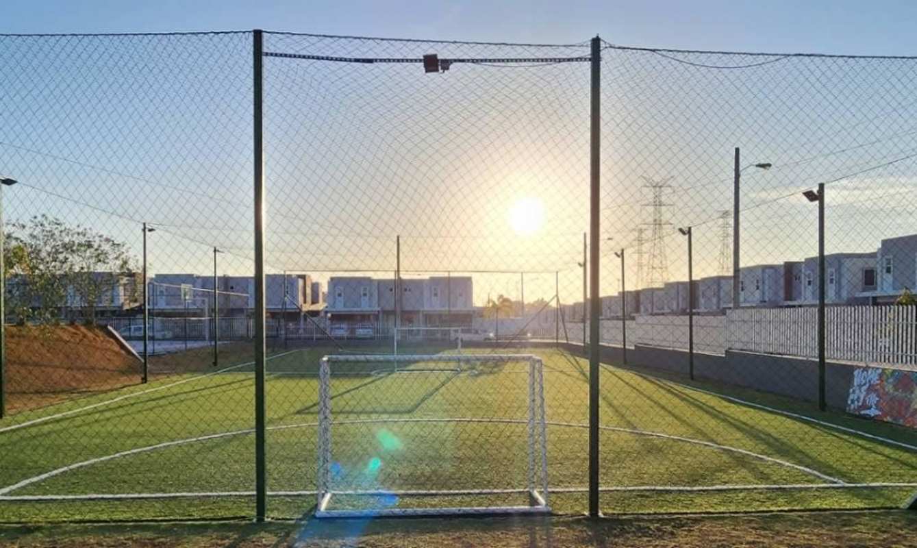 Small soccer field with goal, safety netting and homes around in PH Augusta Panama City